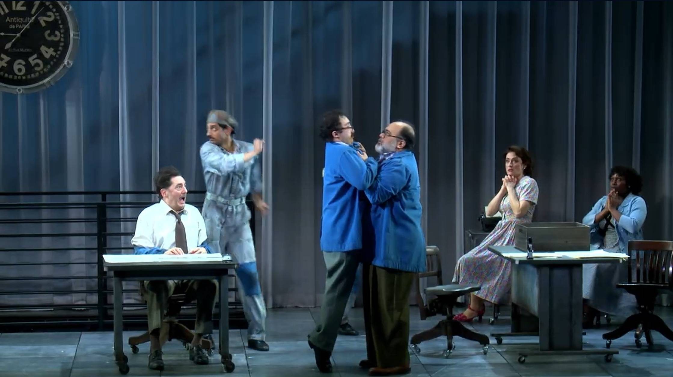 Will Dagger and Richard Ruiz Henry (foreground) with members of the company in a scene from Rhinoceros by Eugene Ionesco, translated by Derek Prouse, adapted by Frank Galati, choreographed by Emily Coates, and directed by Liz Diamond. Yale Repertory Theatre, March 6–28, 2026.