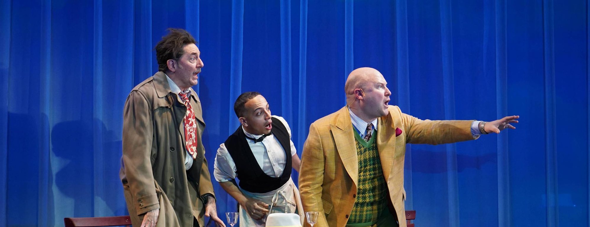 Reg Rogers, Jeremy A. Fuentes, and Phillip Taratula in a scene from Rhinoceros by Eugene Ionesco, translated by Derek Prouse, adapted by Frank Galati, choreographed by Emily Coates, and directed by Liz Diamond. Yale Repertory Theatre, March 6–28, 2026. Photo © Carol Rosegg